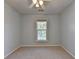 A bright bedroom with a ceiling fan has a window letting in natural light with neutral colored carpet at 2008 Hailston Dr, Duluth, GA 30097