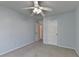 A bright bedroom with a ceiling fan has a window letting in natural light with neutral colored carpet at 2008 Hailston Dr, Duluth, GA 30097
