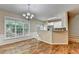 Open dining area with hardwood floors next to white kitchen and breakfast bar at 2008 Hailston Dr, Duluth, GA 30097