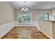Bright dining room features hardwood floors, wainscoting, and modern chandelier lighting at 2008 Hailston Dr, Duluth, GA 30097