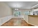 Bright dining room features hardwood floors, wainscoting, and modern chandelier lighting at 2008 Hailston Dr, Duluth, GA 30097