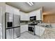 Kitchen with stainless steel appliances, white cabinets, and granite countertops at 2008 Hailston Dr, Duluth, GA 30097