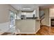 View of open concept kitchen with white cabinets and breakfast bar at 2008 Hailston Dr, Duluth, GA 30097