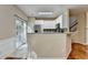 View of open concept kitchen with white cabinets and breakfast bar at 2008 Hailston Dr, Duluth, GA 30097