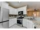 Updated kitchen with stainless steel appliances and mosaic backsplash at 2008 Hailston Dr, Duluth, GA 30097
