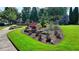 Well-manicured front yard with lush green grass, tasteful plantings, and mature trees at 2008 Hailston Dr, Duluth, GA 30097