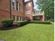 Lush green backyard with mature trees, a charming patio, and well-maintained landscaping at 6205 Arnall Nw Ct, Acworth, GA 30101
