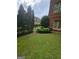 Lush green backyard featuring mature trees and shrubs at 6205 Arnall Nw Ct, Acworth, GA 30101