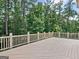 Wooden deck offering scenic views of the surrounding forest, ideal for relaxing and outdoor activities at 6205 Arnall Nw Ct, Acworth, GA 30101