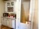 Charming bar area with custom cabinets, granite countertop, wine rack, and beverage fridge at 6205 Arnall Nw Ct, Acworth, GA 30101