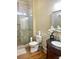 Stylish bathroom featuring a glass-enclosed shower, dark vanity with marble top, and modern fixtures at 6205 Arnall Nw Ct, Acworth, GA 30101