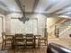 Dining room features exposed brick walls, plantation shutters, statement lighting, and wood flooring at 6205 Arnall Nw Ct, Acworth, GA 30101