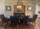 Formal dining room with wainscoting, hardwood flooring, elegant decor, and seating for six at 6205 Arnall Nw Ct, Acworth, GA 30101