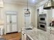 Bright kitchen features an island, stainless steel appliances, and custom white cabinets at 6205 Arnall Nw Ct, Acworth, GA 30101