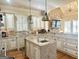 Spacious kitchen features an island, stainless steel appliances, and custom white cabinets at 6205 Arnall Nw Ct, Acworth, GA 30101