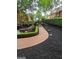 Beautifully landscaped yard featuring a brick pathway, manicured hedges, and dark mulch, accentuating the home's exterior at 6205 Arnall Nw Ct, Acworth, GA 30101