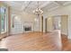 Spacious living room with coffered ceiling, fireplace, built-in shelving, and hardwood flooring at 6205 Arnall Nw Ct, Acworth, GA 30101