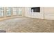 Spacious living room bathed in natural light, enhanced by neutral carpet and classic trim at 6205 Arnall Nw Ct, Acworth, GA 30101