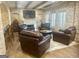 Inviting living room with brick walls, hardwood floors, and comfortable leather seating around a fireplace at 6205 Arnall Nw Ct, Acworth, GA 30101
