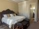 Comfortable bedroom featuring a king-size bed, ensuite bathroom and a bench at the foot of the bed at 6205 Arnall Nw Ct, Acworth, GA 30101