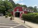 The White Street Farms Barn has large doors under the sign at 1002 Harvest Park Ln, Suwanee, GA 30024