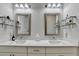 Stylish bathroom with double sinks, quartz countertop, and decorative shelving at 1002 Harvest Park Ln, Suwanee, GA 30024