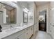 Modern bathroom with double sinks, marble countertops, and glass-enclosed shower at 1002 Harvest Park Ln, Suwanee, GA 30024