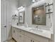 Elegant bathroom featuring dual vanities, framed mirrors, and modern lighting fixtures at 1002 Harvest Park Ln, Suwanee, GA 30024