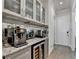 Butler's pantry has granite countertops, custom cabinets, a wine fridge, and a coffee maker at 1002 Harvest Park Ln, Suwanee, GA 30024