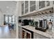 Butler's pantry has granite countertops, custom cabinets, a wine fridge, and a coffee maker at 1002 Harvest Park Ln, Suwanee, GA 30024