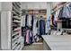 Spacious walk-in closet with custom shelving, hanging rods, and built-in storage at 1002 Harvest Park Ln, Suwanee, GA 30024