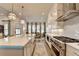 Spacious kitchen features a large island, stainless steel appliances, and an open floorplan at 1002 Harvest Park Ln, Suwanee, GA 30024