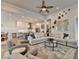 Open concept living room with large sectional sofa flowing into kitchen and dining areas at 1002 Harvest Park Ln, Suwanee, GA 30024