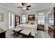 The main bedroom features a ceiling fan, windows, and a neutral color palette at 1002 Harvest Park Ln, Suwanee, GA 30024