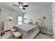 Neutral primary bedroom with ceiling fan, dresser, king bed, and side tables offering a calming retreat at 1002 Harvest Park Ln, Suwanee, GA 30024