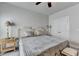 Neutral primary bedroom with ceiling fan, king bed, side tables and double door closet providing ample space at 1002 Harvest Park Ln, Suwanee, GA 30024