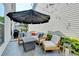 Outdoor patio area with furniture, string lights, gas grill and an umbrella provides a relaxing atmosphere at 1002 Harvest Park Ln, Suwanee, GA 30024