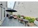 Outdoor patio area with furniture, string lights, privacy landscaping and gas grill perfect for entertaining at 1002 Harvest Park Ln, Suwanee, GA 30024