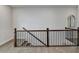 Elegant staircase with wooden handrail, iron spindles, and hardwood flooring at 1002 Harvest Park Ln, Suwanee, GA 30024