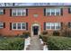 Charming brick townhome featuring a symmetrical facade, classic black shutters, and a well-manicured front garden at 2355 Henderson Mill Ne Rd # 6, Atlanta, GA 30345
