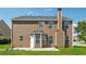 Home exterior highlighting the backyard, chimney, patio, and lush greenery at 3134 Flery Way, Lawrenceville, GA 30046
