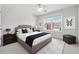 Bright bedroom features a ceiling fan, plush carpet, and a large window with neighborhood views at 3134 Flery Way, Lawrenceville, GA 30046