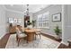 Charming dining room with hardwood floors, elegant chandelier, and a large window at 3134 Flery Way, Lawrenceville, GA 30046