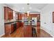 Well-equipped kitchen features dark wood cabinets, granite countertops, and stainless steel appliances at 3134 Flery Way, Lawrenceville, GA 30046
