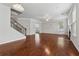 Open living room with wood floors, staircase, and a fireplace, bathed in natural light from large windows at 3134 Flery Way, Lawrenceville, GA 30046