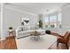 Bright living room features neutral decor, hardwood floors, and a bay window for ample natural light at 3134 Flery Way, Lawrenceville, GA 30046