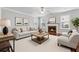Bright living room features neutral walls, fireplace, plush seating, and large windows for abundant natural light at 3134 Flery Way, Lawrenceville, GA 30046