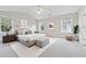Spacious and well-lit main bedroom with a vaulted ceiling, ceiling fan and neutral decor at 3134 Flery Way, Lawrenceville, GA 30046