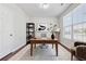 Well lit home office featuring hard wood floors, large desk, and minimalist decor at 3134 Flery Way, Lawrenceville, GA 30046