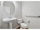 Cozy powder room features a pedestal sink and a round mirror at 3134 Flery Way, Lawrenceville, GA 30046